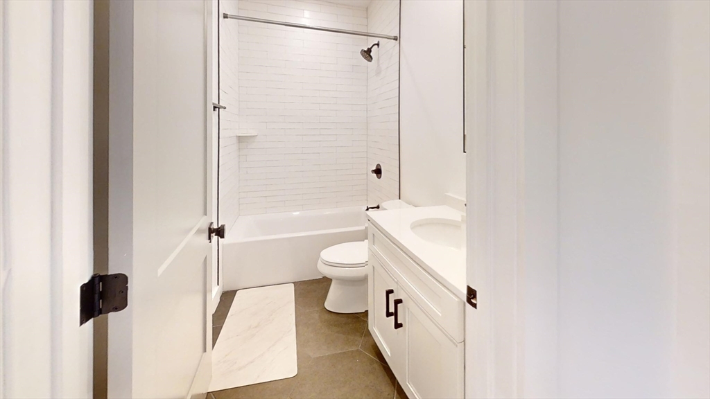 52 Withington Street, Unit 7 Boston, MA 02124 - Photo 15 of 32 a bathroom with a toilet a sink and a shower