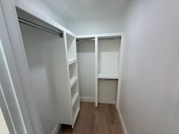 a bathroom with a granite countertop toilet sink and mirror