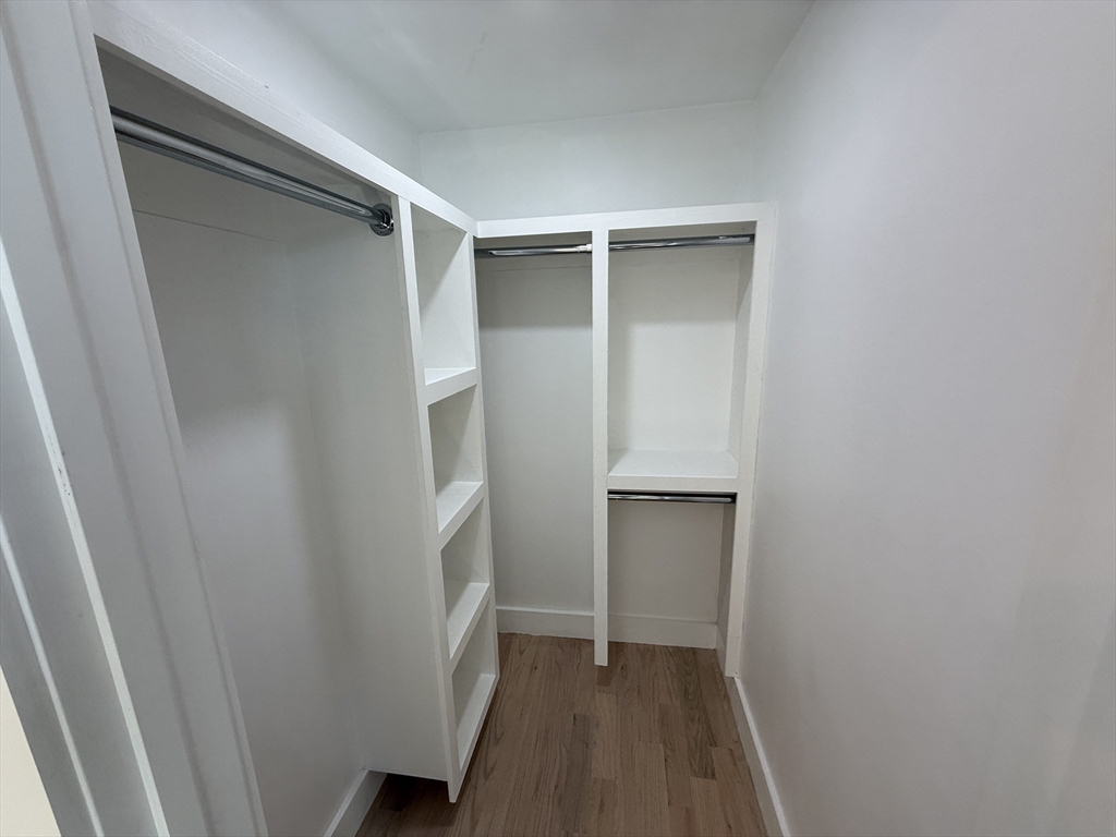 52 Withington Street, Unit 7 Boston, MA 02124 - Photo 16 of 32 a view of walk in closet with wooden floor