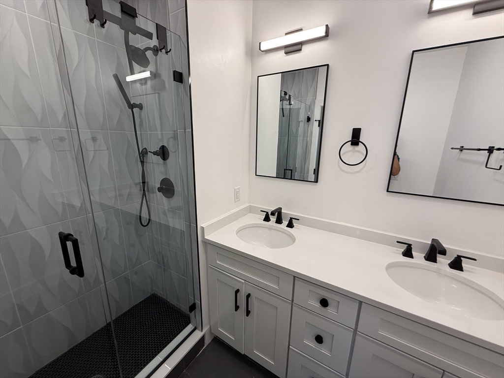 52 Withington Street, Unit 7 Boston, MA 02124 - Photo 18 of 32 a bathroom with double vanity sink and mirror