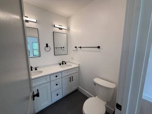 a close up view of a washer and dryer in a small bathroom