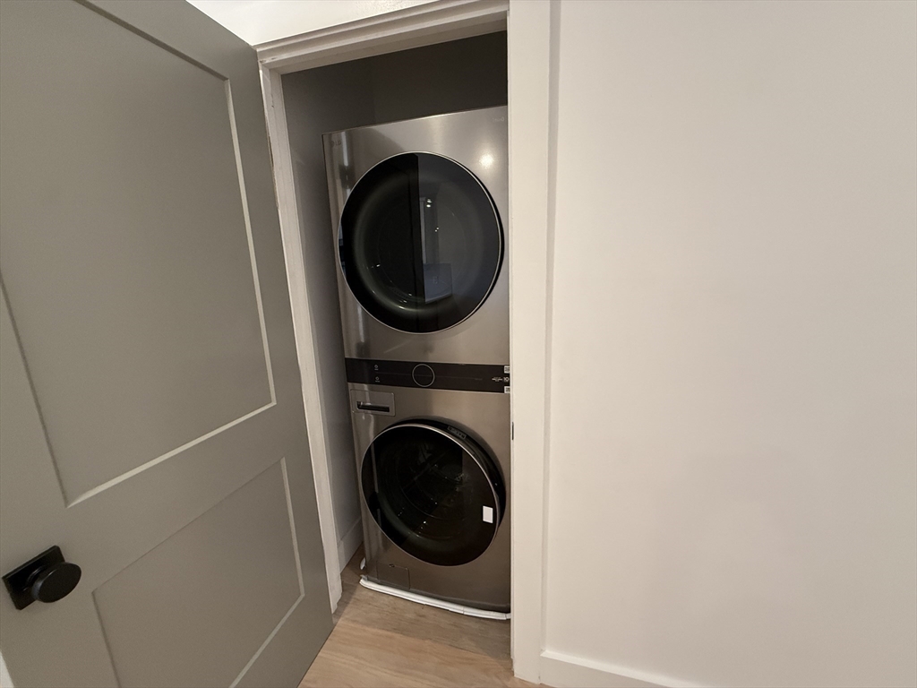 52 Withington Street, Unit 7 Boston, MA 02124 - Photo 21 of 32 a close up view of a washer and dryer in a small bathroom
