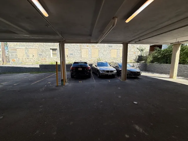 a view of a street that has couple of cars parked on the road