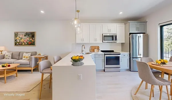 a kitchen with stainless steel appliances a refrigerator and a stove top oven