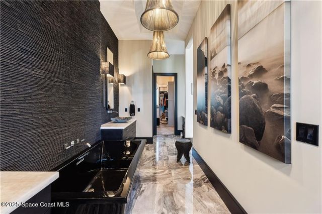 a bathroom with double vanity and a bathtub