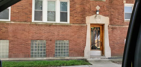 a brick building with a door and a shower