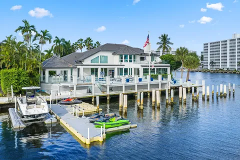 a view of a house with pool fire pit a table and chairs