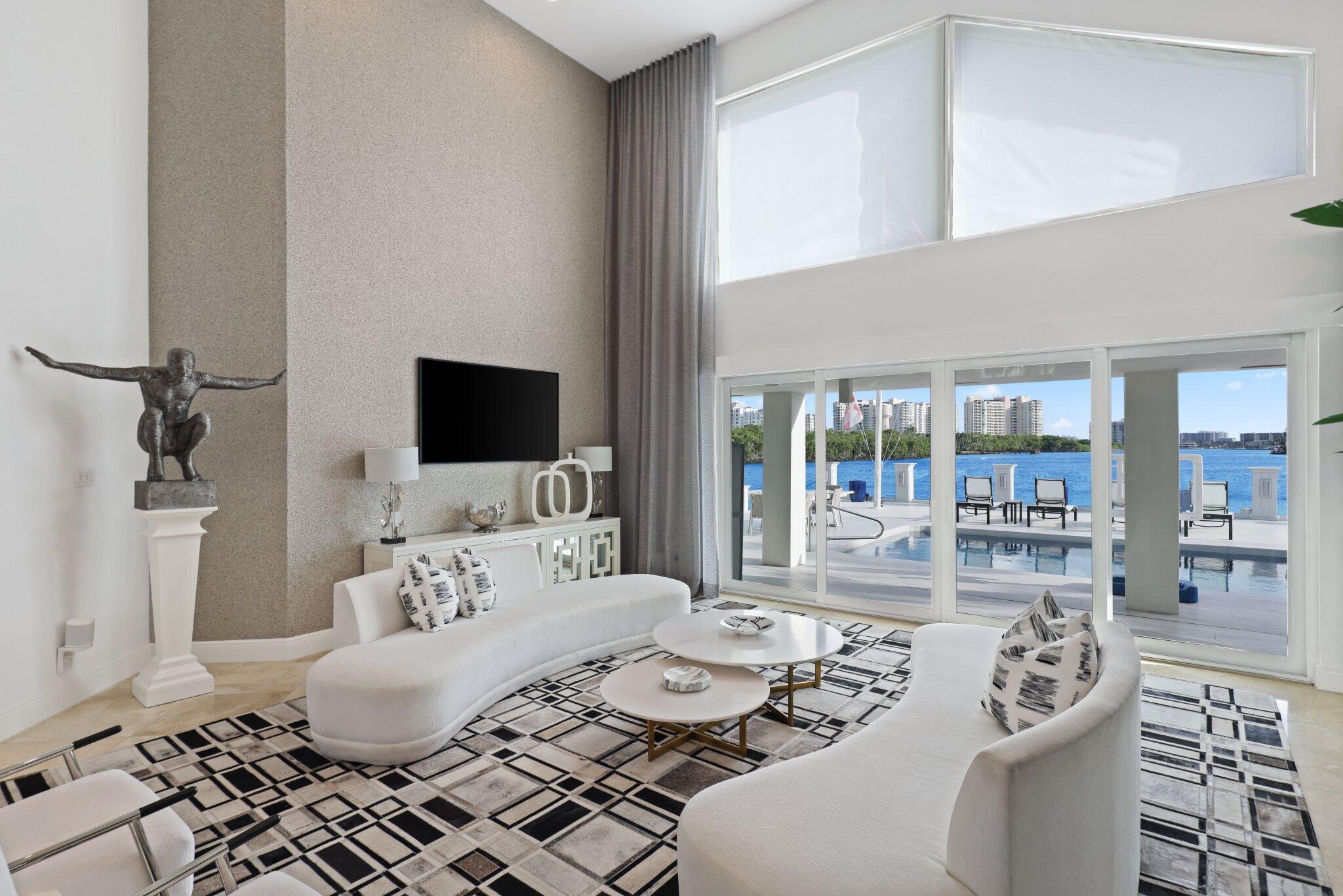 7400 Northeast Orchid Bay Drive Boca Raton, FL 33487 - Photo 7 of 63 a living room with furniture and a flat screen tv