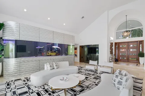 a living room with a floor to ceiling window and wooden floor