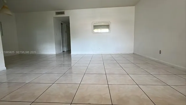 a view of an empty room and window