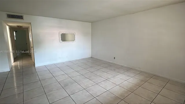 an empty room with a empty space and window