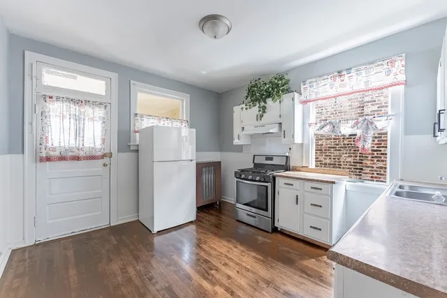 a kitchen with a refrigerator stove and sink
