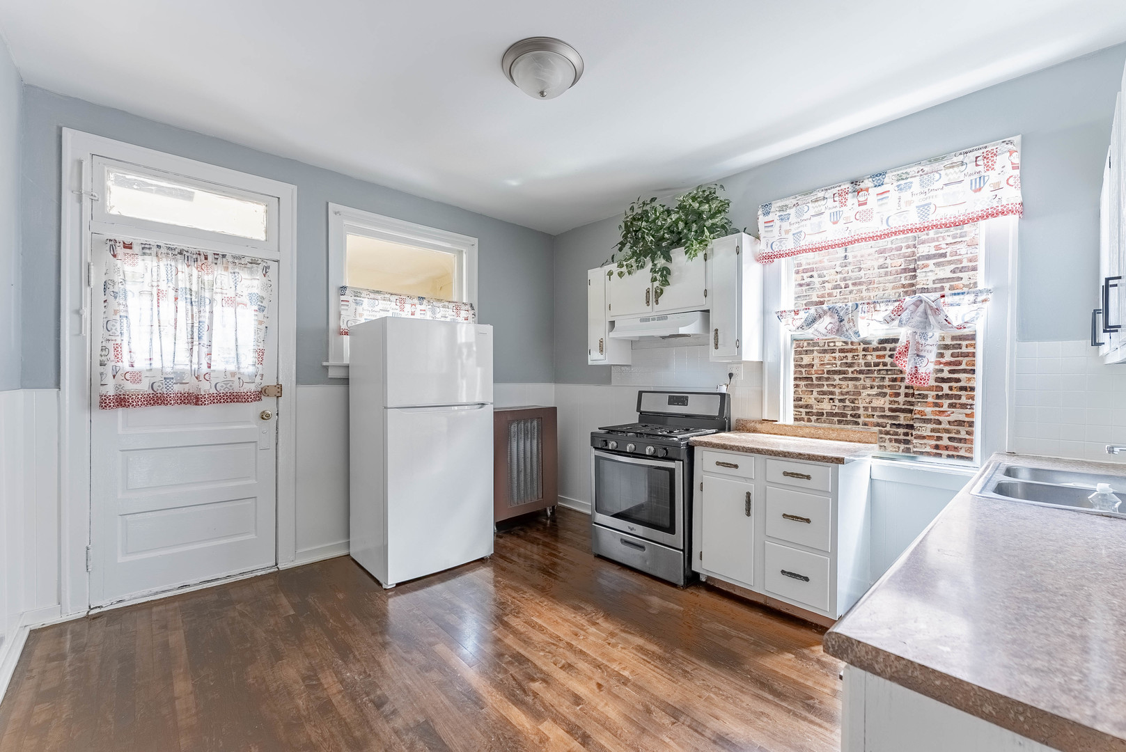 4820 West Wolfram Street, Unit 2 Chicago, IL 60641 - Photo 11 of 18 a kitchen with a refrigerator stove and sink