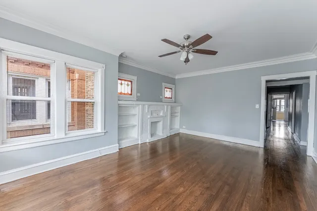 a view of a livingroom with wooden floor and a window