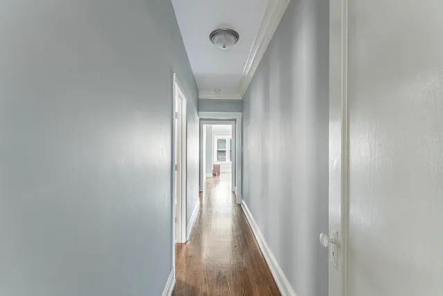 a view of a hallway with wooden floor