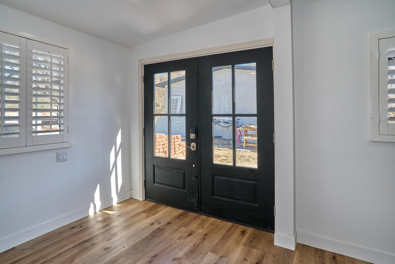 73300 Paradise Avenue Desert Hot Springs, CA 92241 - Photo 22 of 44 a view of an entryway with wooden floor and a window