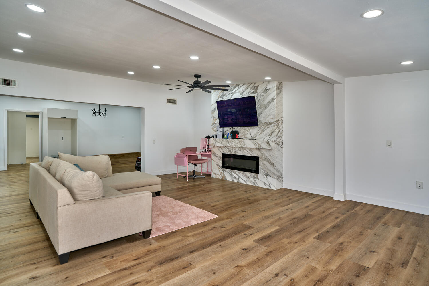 73300 Paradise Avenue Desert Hot Springs, CA 92241 - Photo 23 of 44 a living room with furniture a fireplace and a flat screen tv