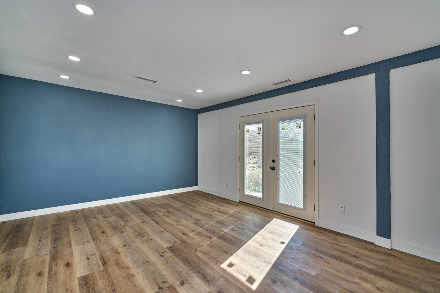 73300 Paradise Avenue Desert Hot Springs, CA 92241 - Photo 32 of 44 an empty room with wooden floor and windows