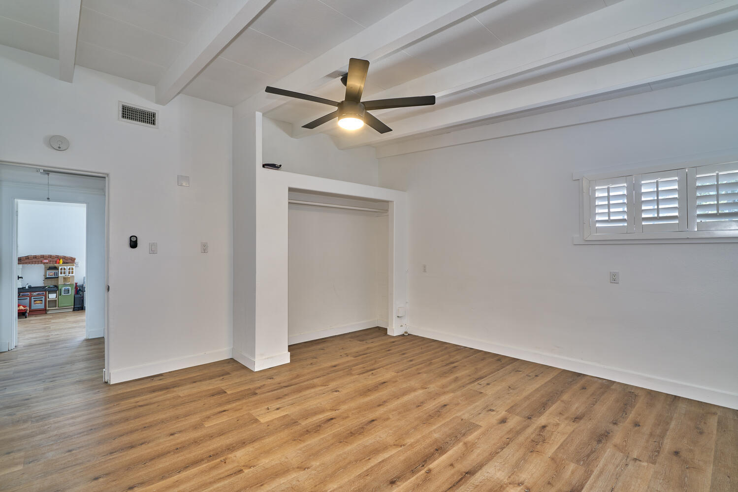 73300 Paradise Avenue Desert Hot Springs, CA 92241 - Photo 41 of 44 wooden floor in an empty room with a window