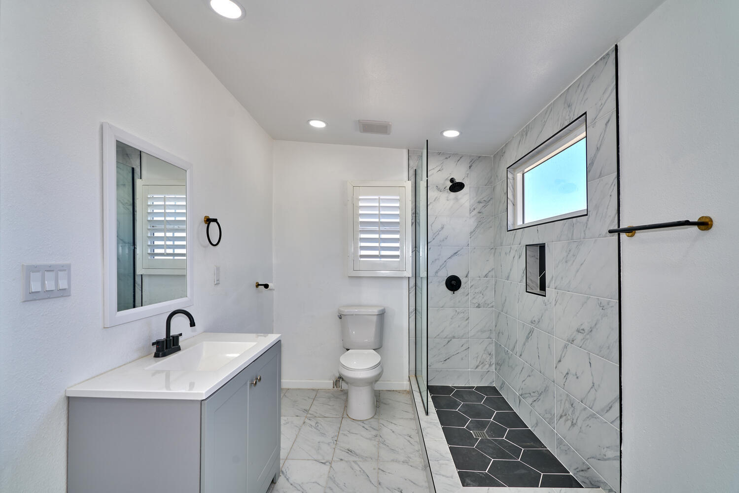73300 Paradise Avenue Desert Hot Springs, CA 92241 - Photo 42 of 44 a spacious bathroom with a sink a toilet and shower