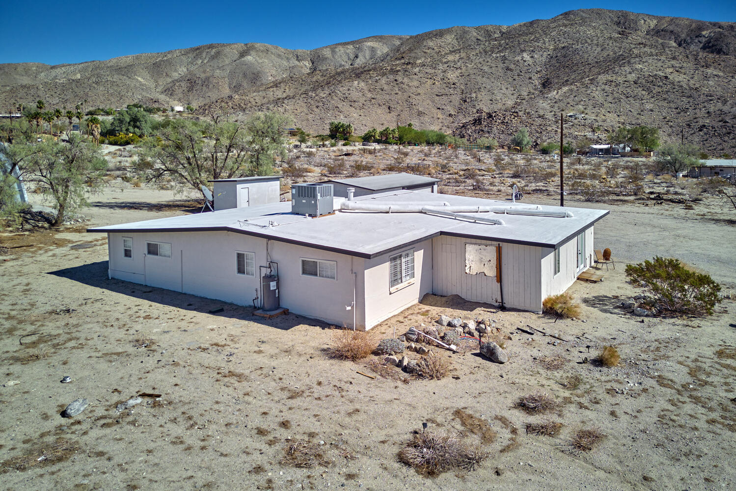 73300 Paradise Avenue Desert Hot Springs, CA 92241 - Photo 10 of 44 a view of a house with a mountain and yard