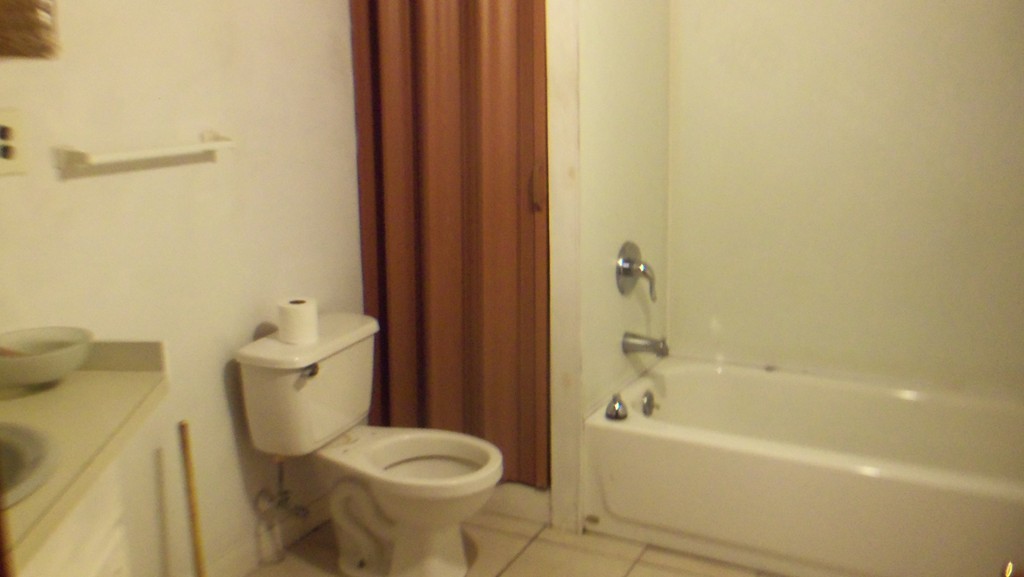 303 Rodman Street Fall River, MA 02721 - Photo 17 of 22 a bathroom with a toilet and a bathtub