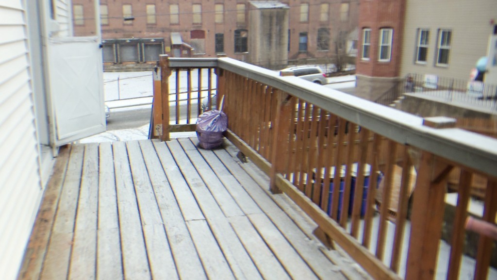 303 Rodman Street Fall River, MA 02721 - Photo 20 of 22 a view of balcony with wooden floor and fence