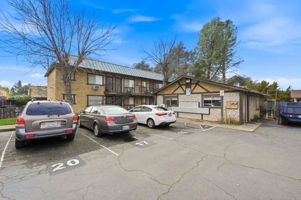 a view of a cars park in front of a house