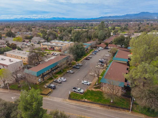 an aerial view of a residential houses with outdoor space and street view