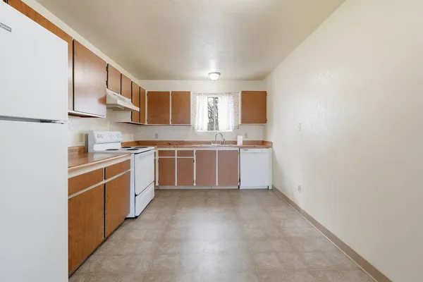a kitchen with stainless steel appliances a sink stove and cabinets