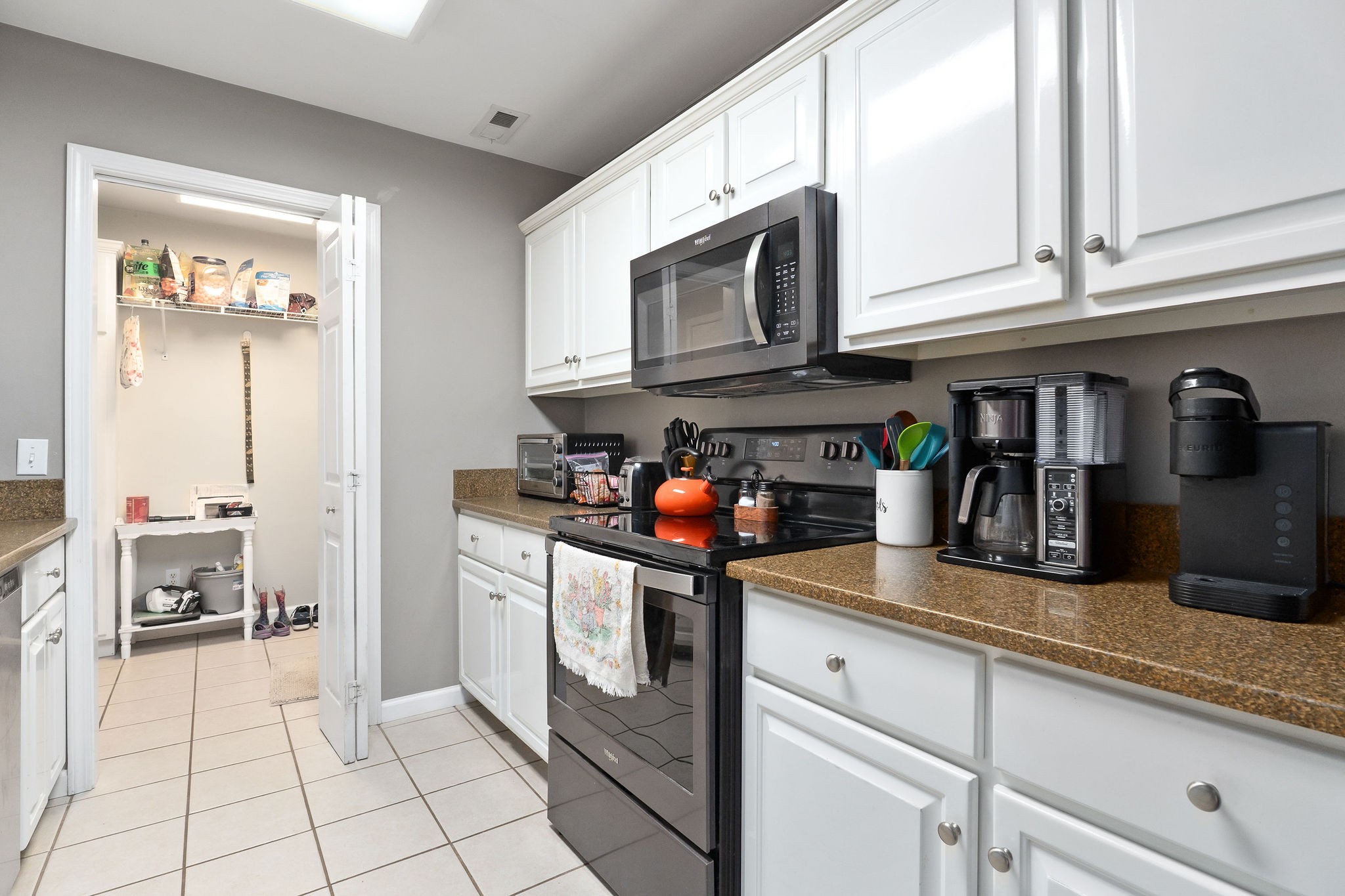143 Old Qualls Road Cookeville, TN 38506 - Photo 20 of 40 a kitchen with stainless steel appliances granite countertop a stove a sink and a microwave
