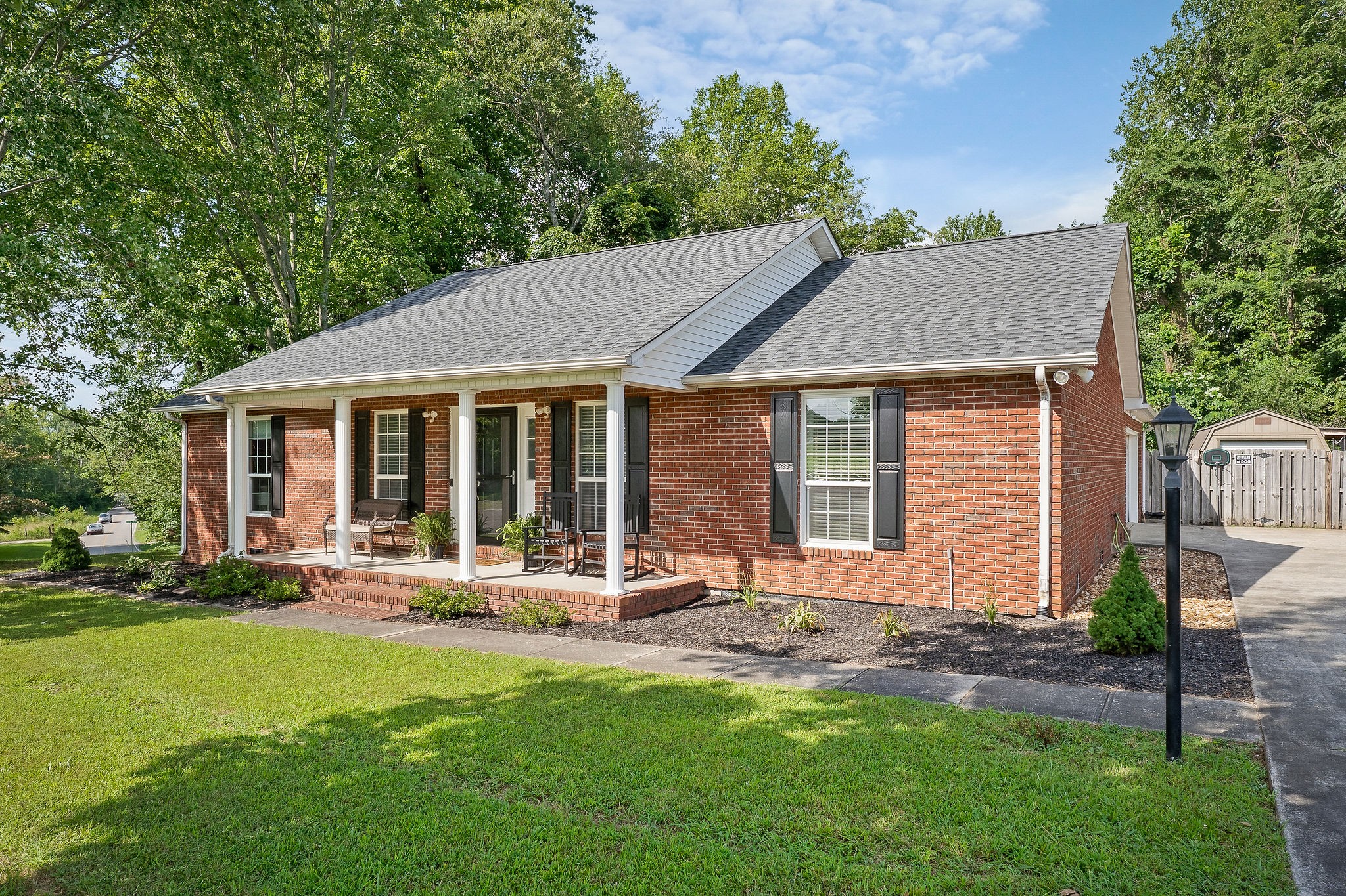 143 Old Qualls Road Cookeville, TN 38506 - Photo 2 of 40 a front view of house with a garden and patio