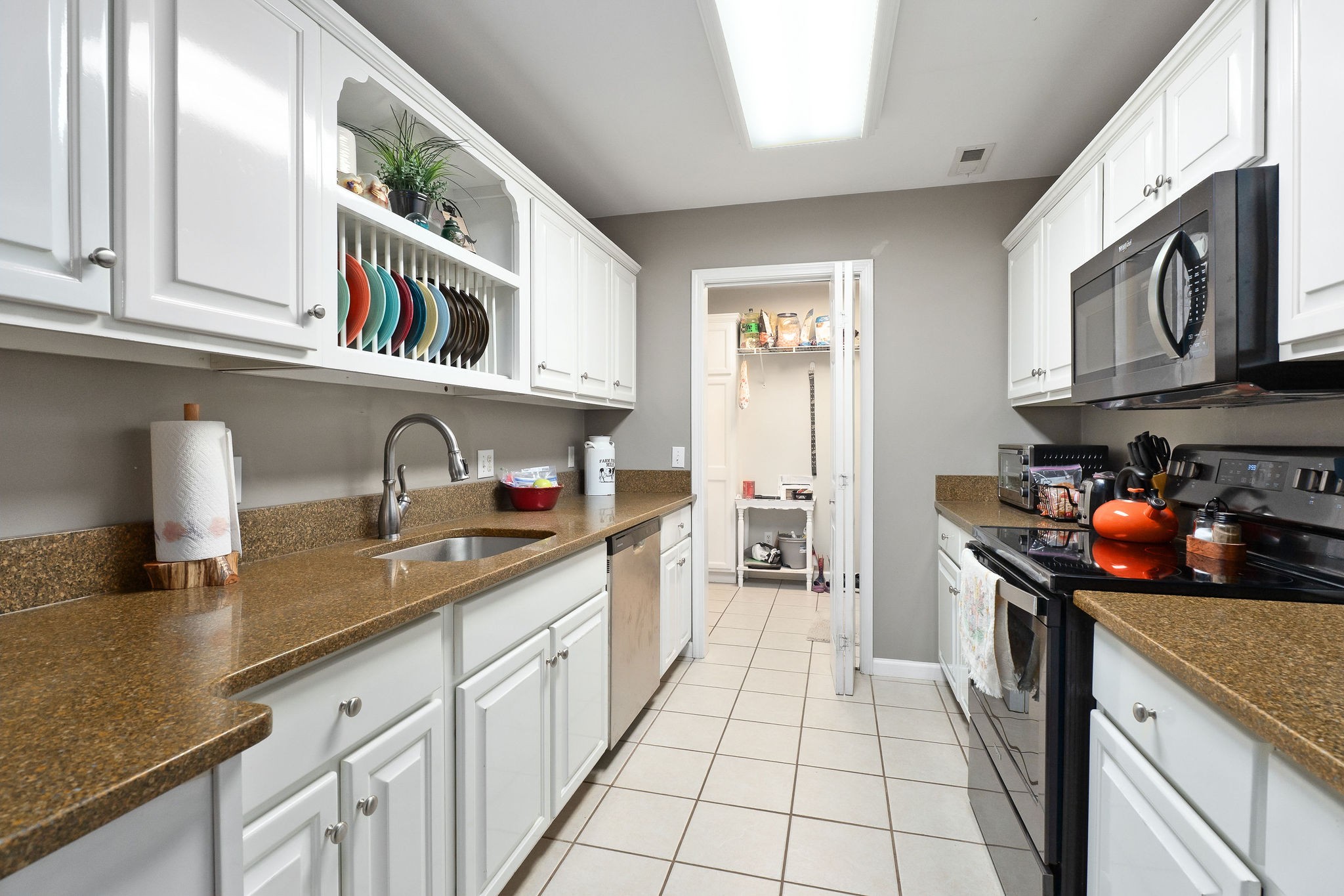 143 Old Qualls Road Cookeville, TN 38506 - Photo 21 of 40 a kitchen with stainless steel appliances granite countertop a sink and dishwasher a stove top oven with wooden floor