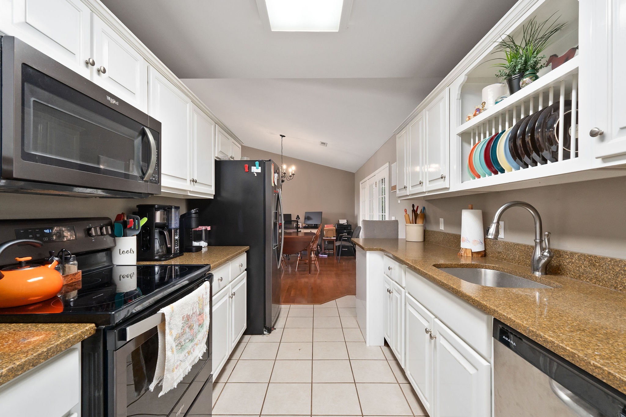 143 Old Qualls Road Cookeville, TN 38506 - Photo 23 of 40 a kitchen with stainless steel appliances granite countertop a sink and cabinets
