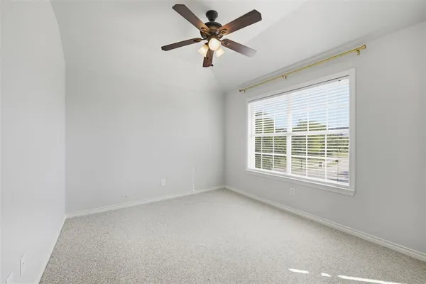 a view of a livingroom with a ceiling fan and window
