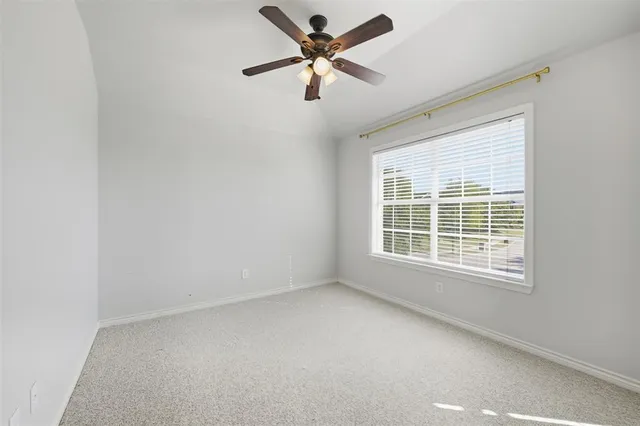 a view of a livingroom with a ceiling fan and window