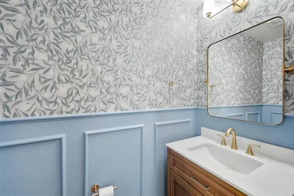 a bathroom with a sink and vanity