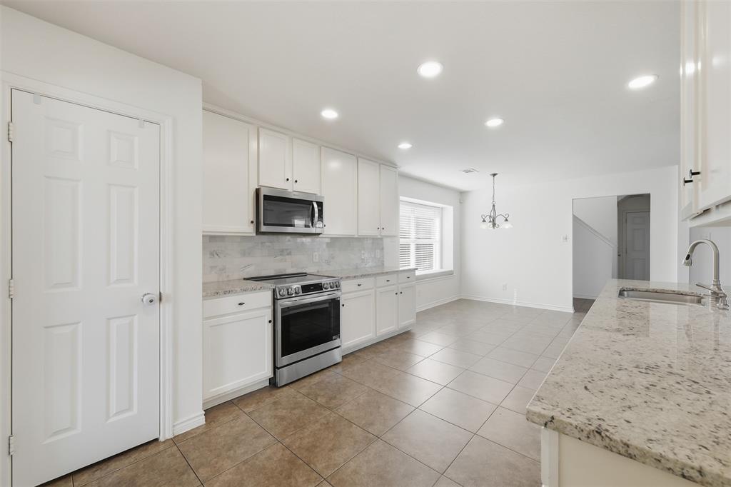 5408 Bridgeport Road McKinney, TX 75071 - Photo 2 of 22 a large kitchen with a stove and a sink