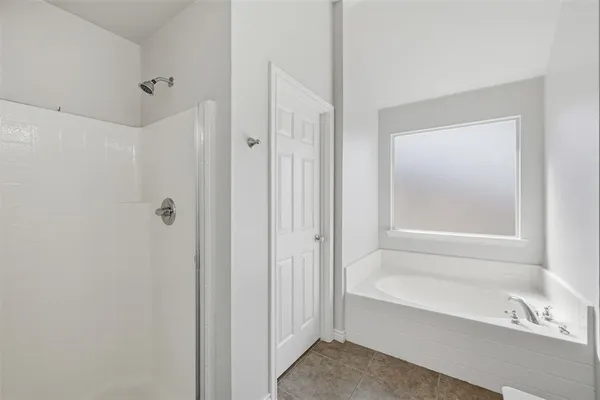 a bathroom with a bathtub shower and a sink