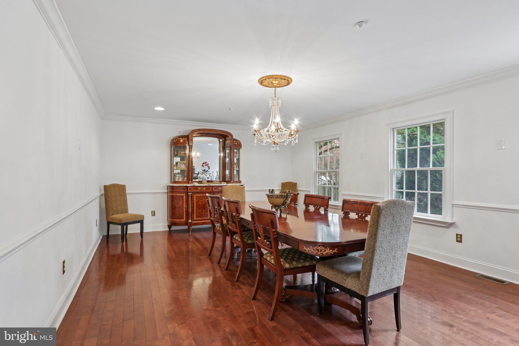 209 Welsh Road Ambler, PA 19002 - Photo 26 of 80 a view of a dining room with furniture a chandelier and wooden floor