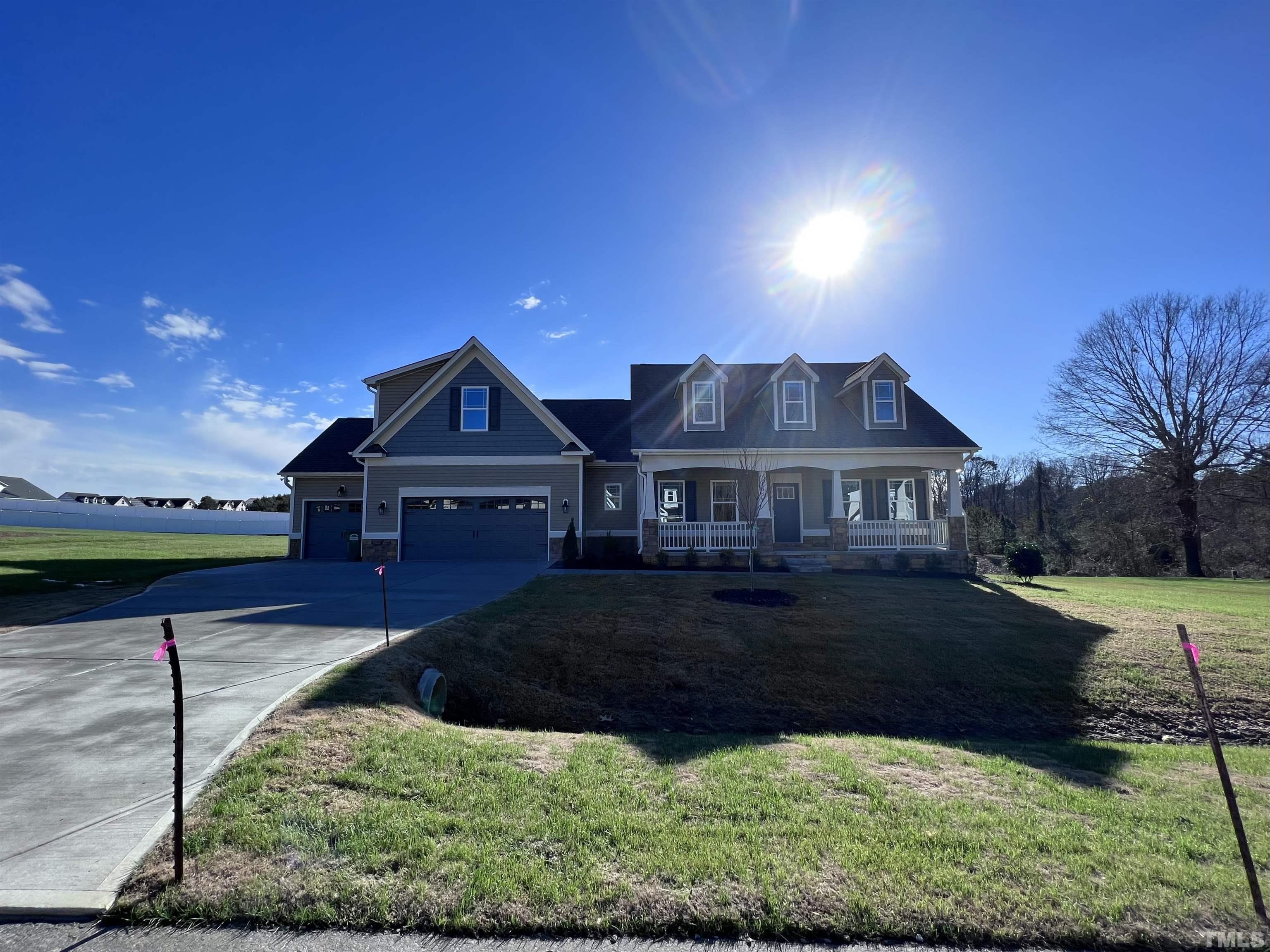 59 Cricket Hill Way Benson, NC 27504 - Photo 1 of 28 a front view of a house with garden