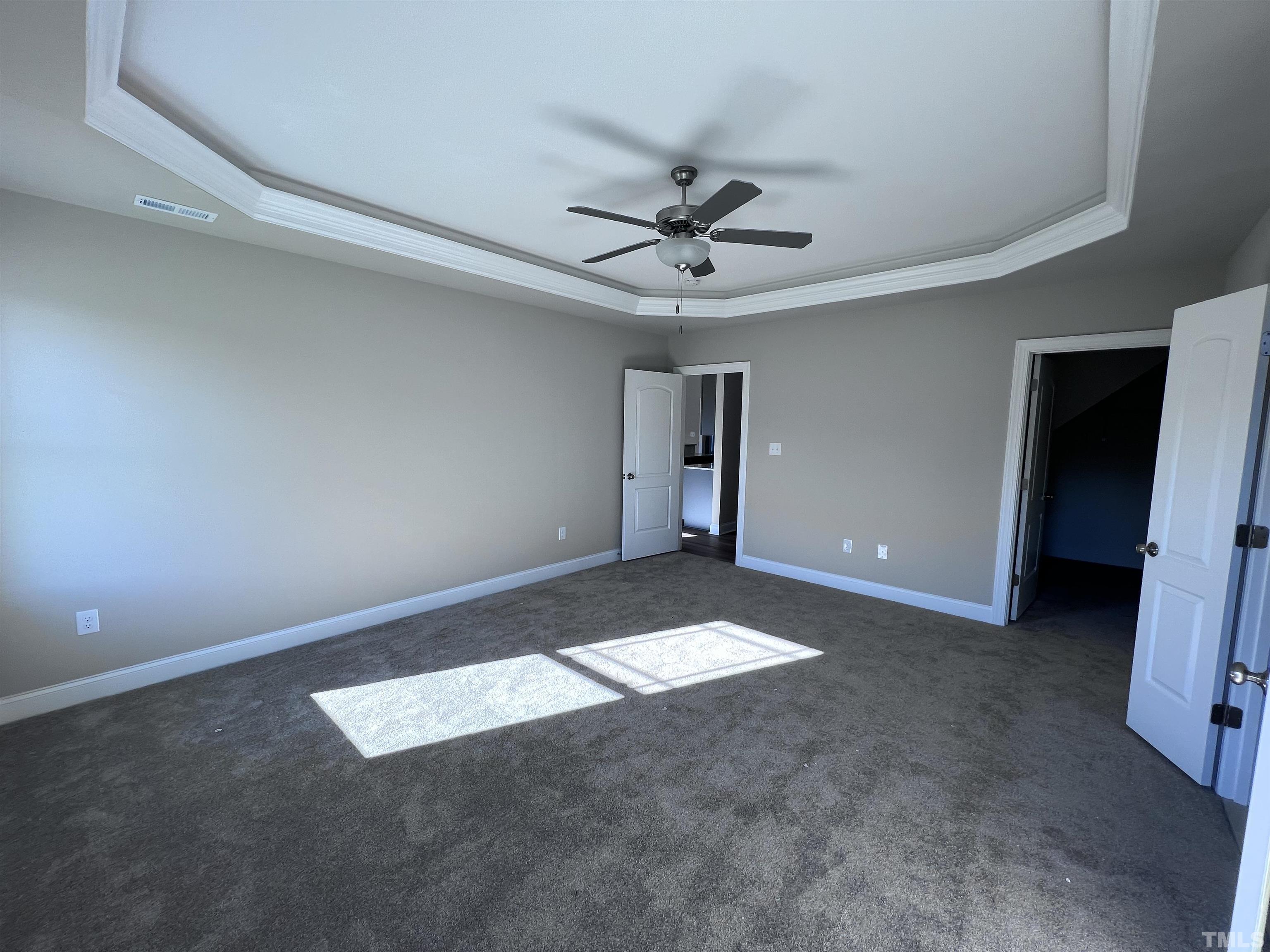 59 Cricket Hill Way Benson, NC 27504 - Photo 11 of 28 a view of an empty room with a ceiling fan