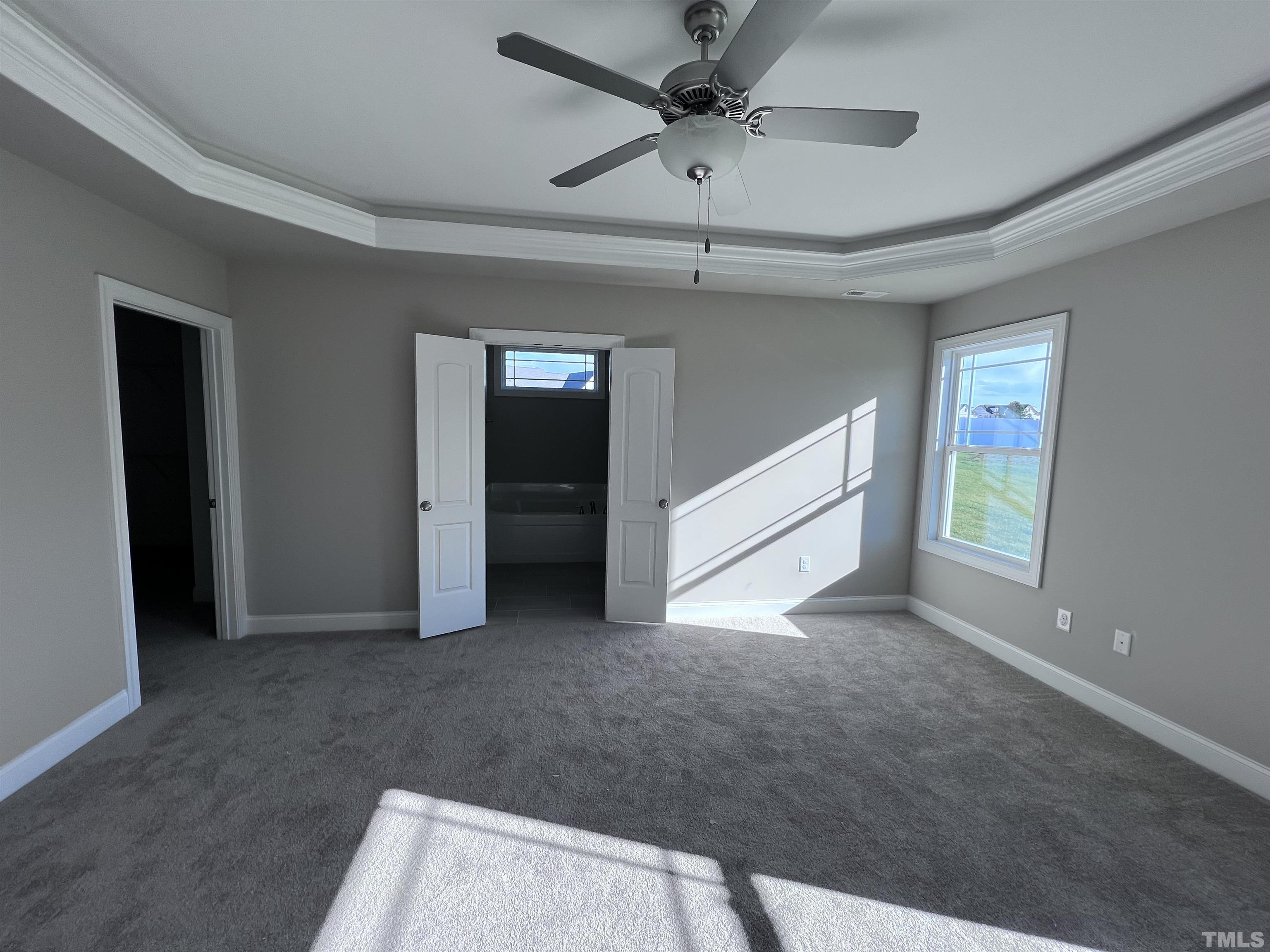 59 Cricket Hill Way Benson, NC 27504 - Photo 13 of 28 an empty room with chandelier fan and windows