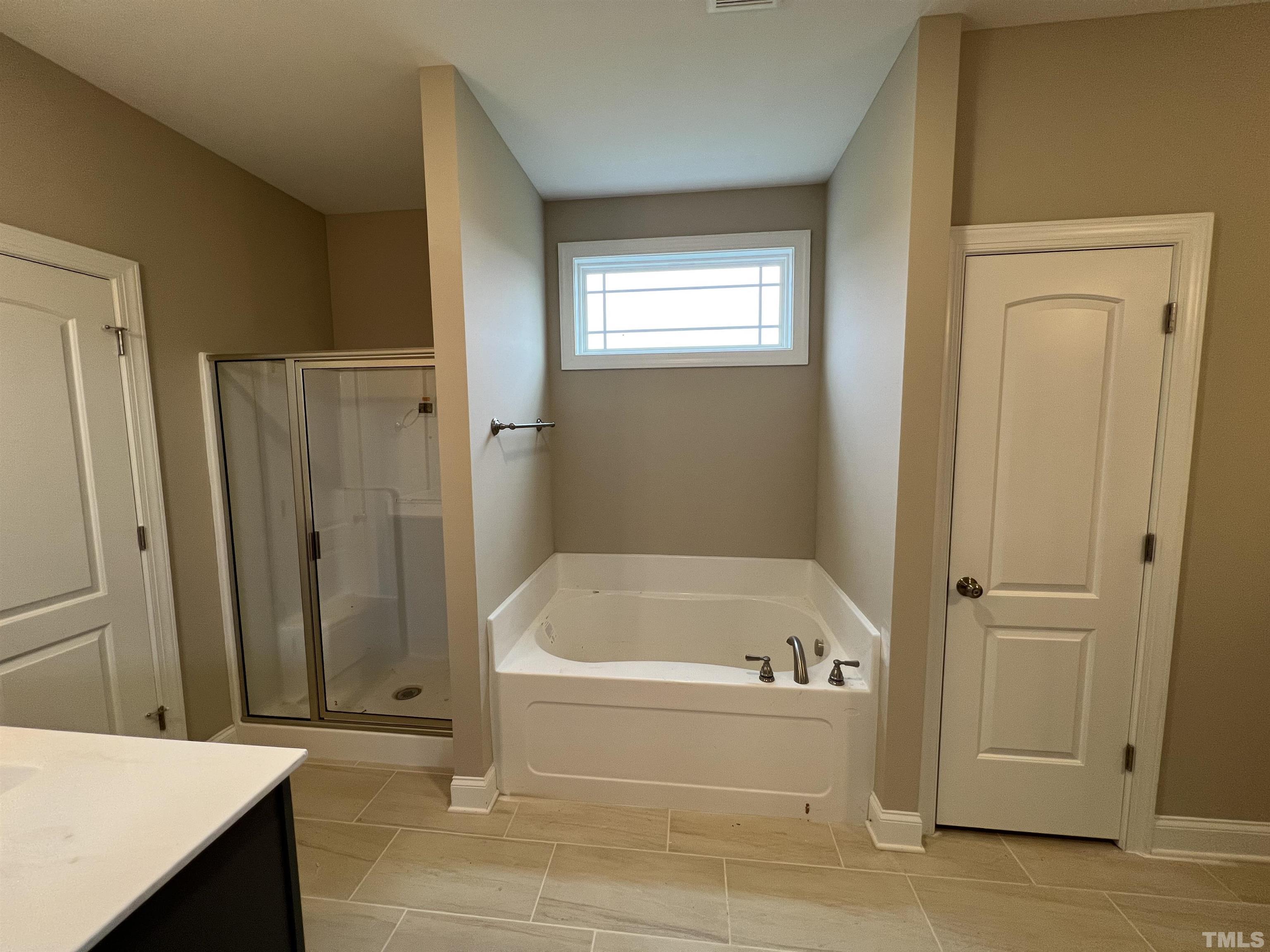 59 Cricket Hill Way Benson, NC 27504 - Photo 15 of 28 a bathroom with a tub and shower