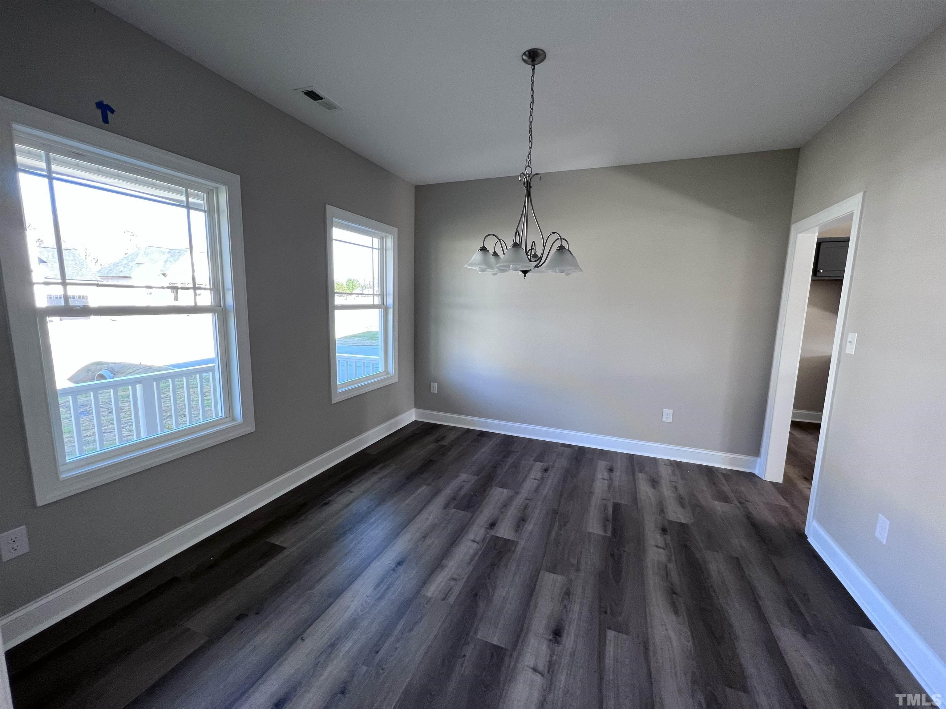59 Cricket Hill Way Benson, NC 27504 - Photo 5 of 28 a view of an empty room with wooden floor and a window