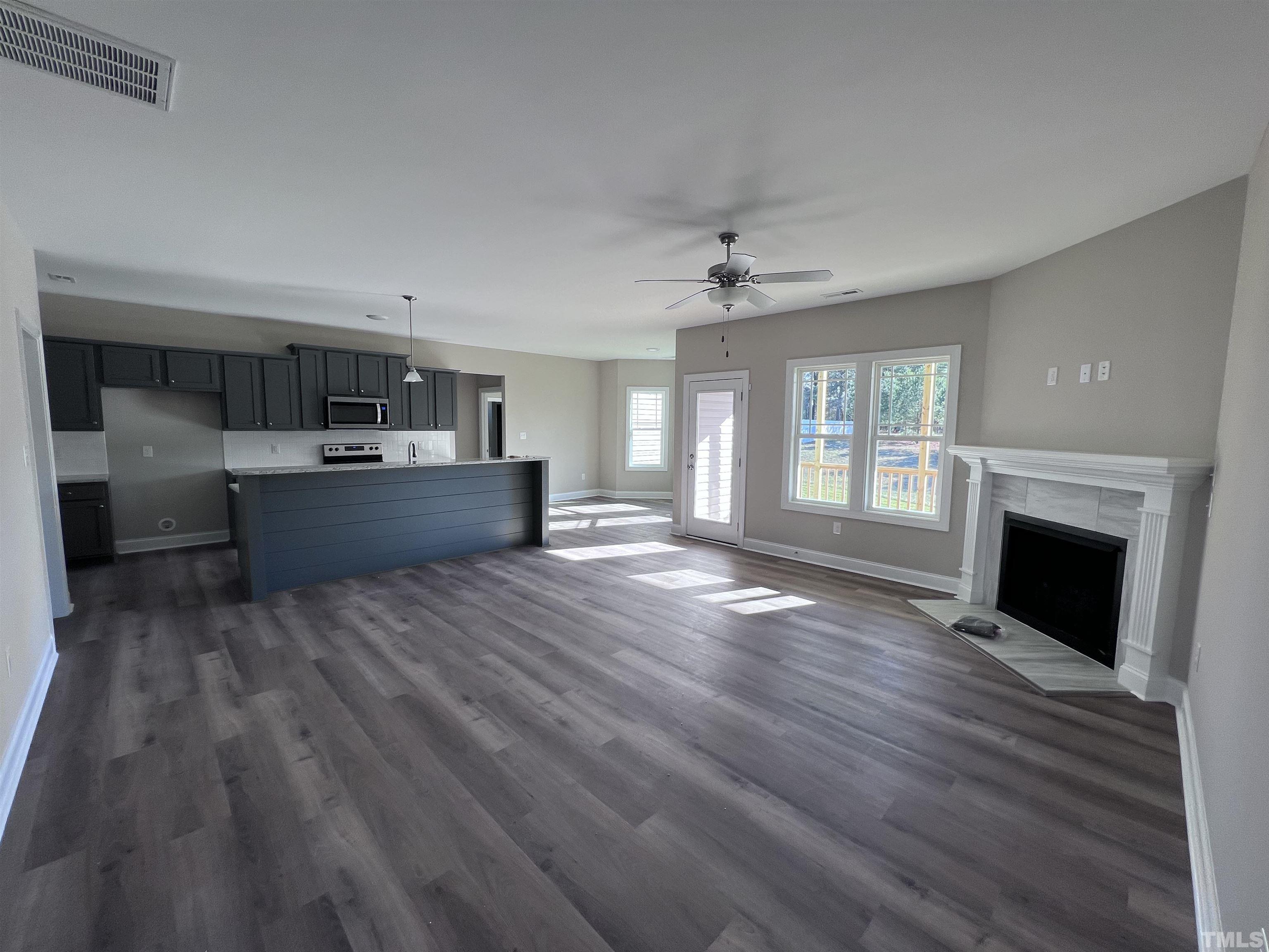 59 Cricket Hill Way Benson, NC 27504 - Photo 8 of 28 a large kitchen with cabinets wooden floor and a fireplace