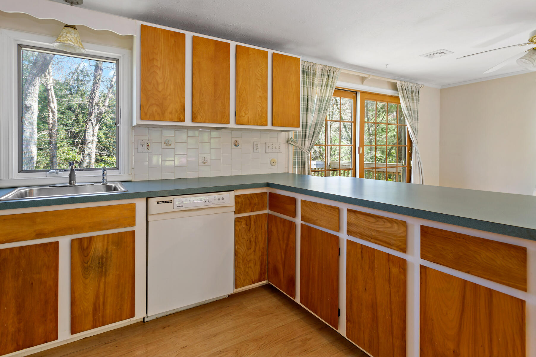 1092 Osterville West Barnstable Road Barnstable, MA 02648 - Photo 11 of 25 a view of a kitchen with granite countertop wooden cabinets a sink and a window