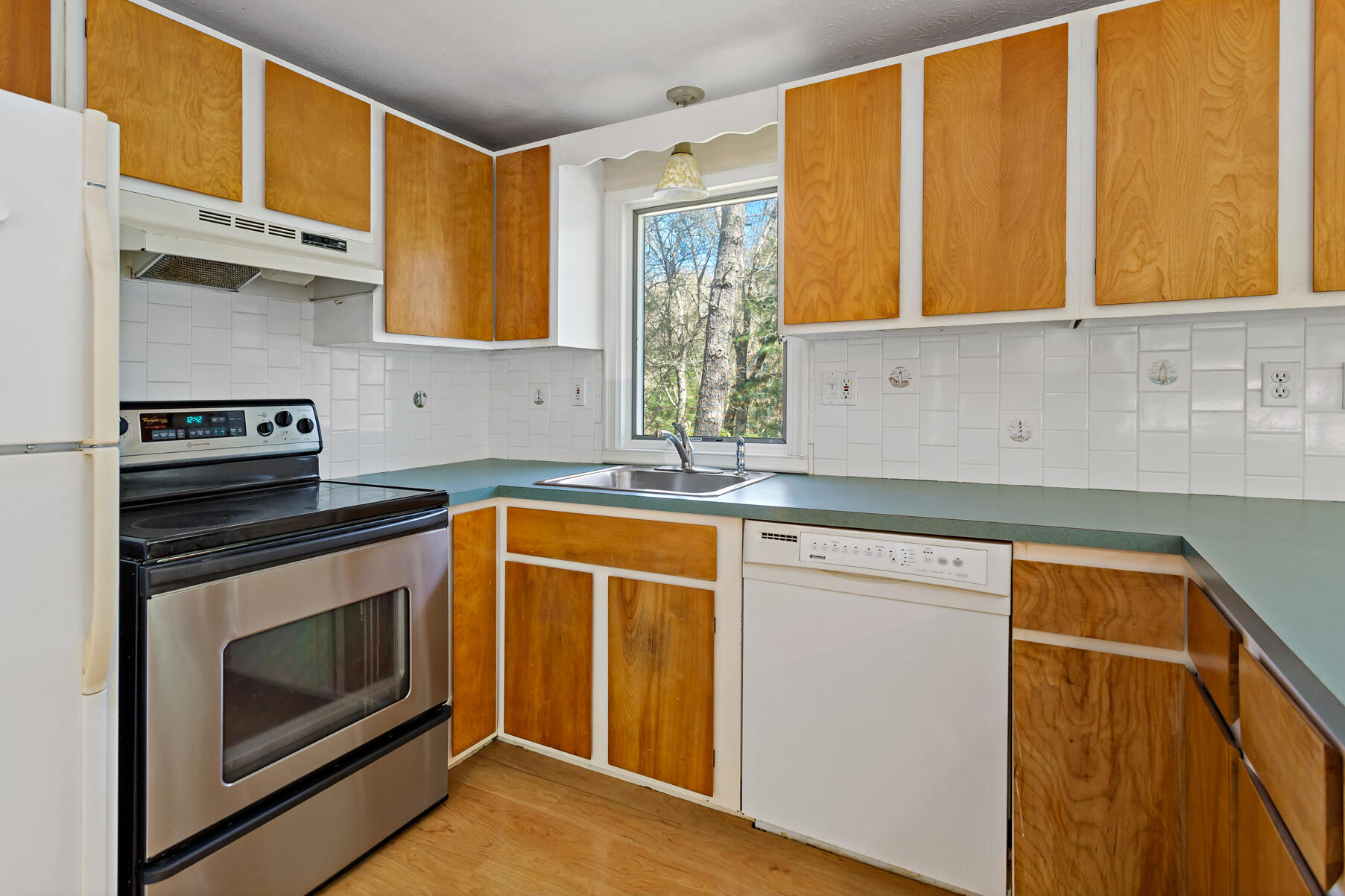 1092 Osterville West Barnstable Road Barnstable, MA 02648 - Photo 12 of 25 a kitchen with granite countertop cabinets stainless steel appliances and a sink