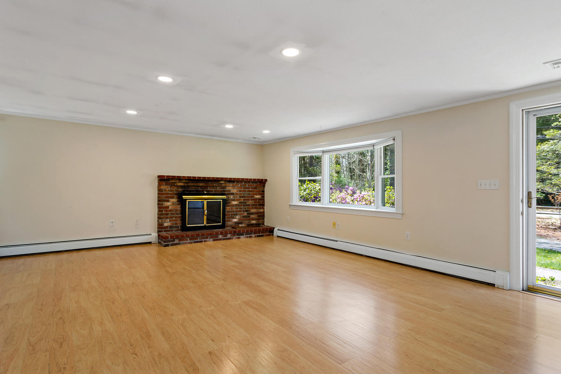 1092 Osterville West Barnstable Road Barnstable, MA 02648 - Photo 4 of 25 an empty room with fireplace and windows