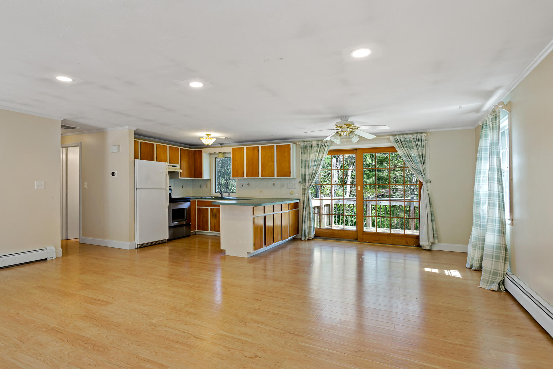 1092 Osterville West Barnstable Road Barnstable, MA 02648 - Photo 6 of 25 a open kitchen with stainless steel appliances granite countertop a stove top oven a sink dishwasher and a refrigerator with wooden floor